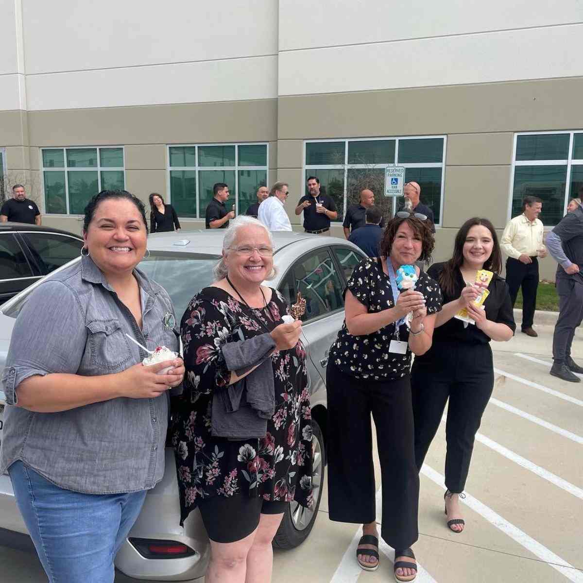 Smiling employees enjoying Frosty Brothers ice cream treats during a corporate appreciation event in San Antonio, Texas.