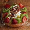 Frosty Cottage made with fresh strawberries, kiwi, grapes, cantaloupe, mango, cottage cheese, honey and pecans at Frosty Brothers Shaved Ice & Snacks in San Antonio, Texas.