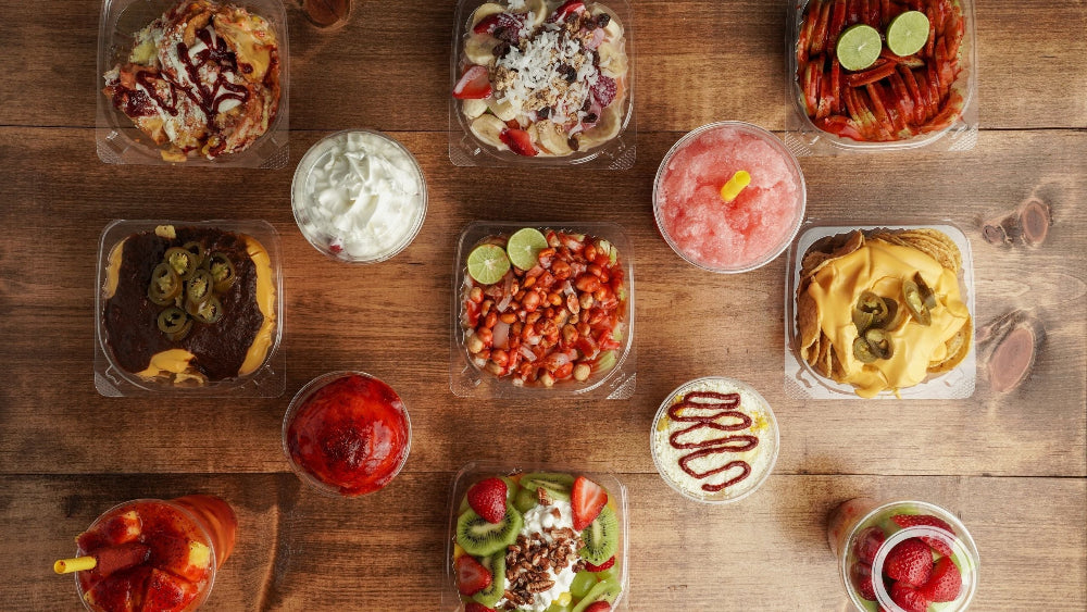 Assorted small dishes of food on a wooden surface