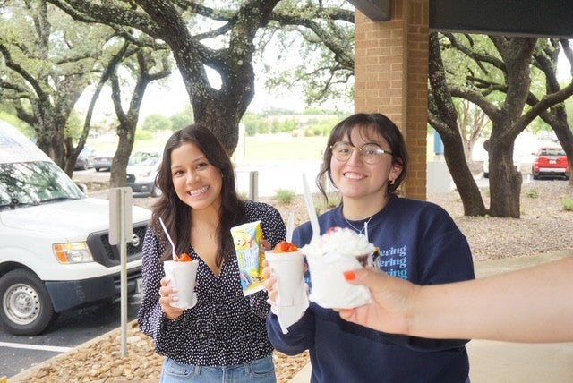 employees enjoying shaved ice, snacks, and frozen treats from the Frosty Brothers Ice Cream Truck during a corporate employee appreciation event in San Antonio, Texas.
