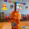 Authentic mangonada made with mango shaved ice, chamoy, Tajín, fresh mango, and a tamarind candy straw at Frosty Brothers shop in San Antonio.