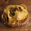 Crispy Nacho tortilla chips topped with warm nacho cheese and sliced jalapeños, freshly prepared at Frosty Brothers Shaved Ice & Snacks in San Antonio, Texas.