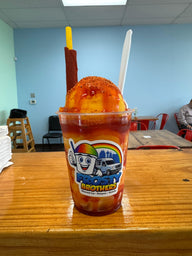 Authentic mangonada made with mango shaved ice, chamoy, Tajín, fresh mango, and a tamarind candy straw at Frosty Brothers in San Antonio.