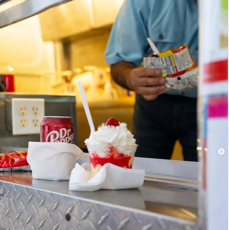 Freshly made ice cream sundae topped with whipped cream and a cherry served from the Frosty Brothers Ice Cream Truck in San Antonio.