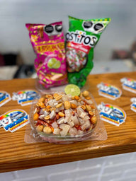 Traditional Mexican Tostilocos made with chips, cucumber, jicama, peanuts, Japanese peanuts, chamoy, lime, and Mexican candy at Frosty Brothers.