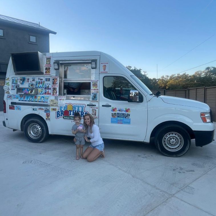 Frosty Brothers ice cream truck at a Birthday event in San Antonio, with a smiling mom and child posing for a photo.