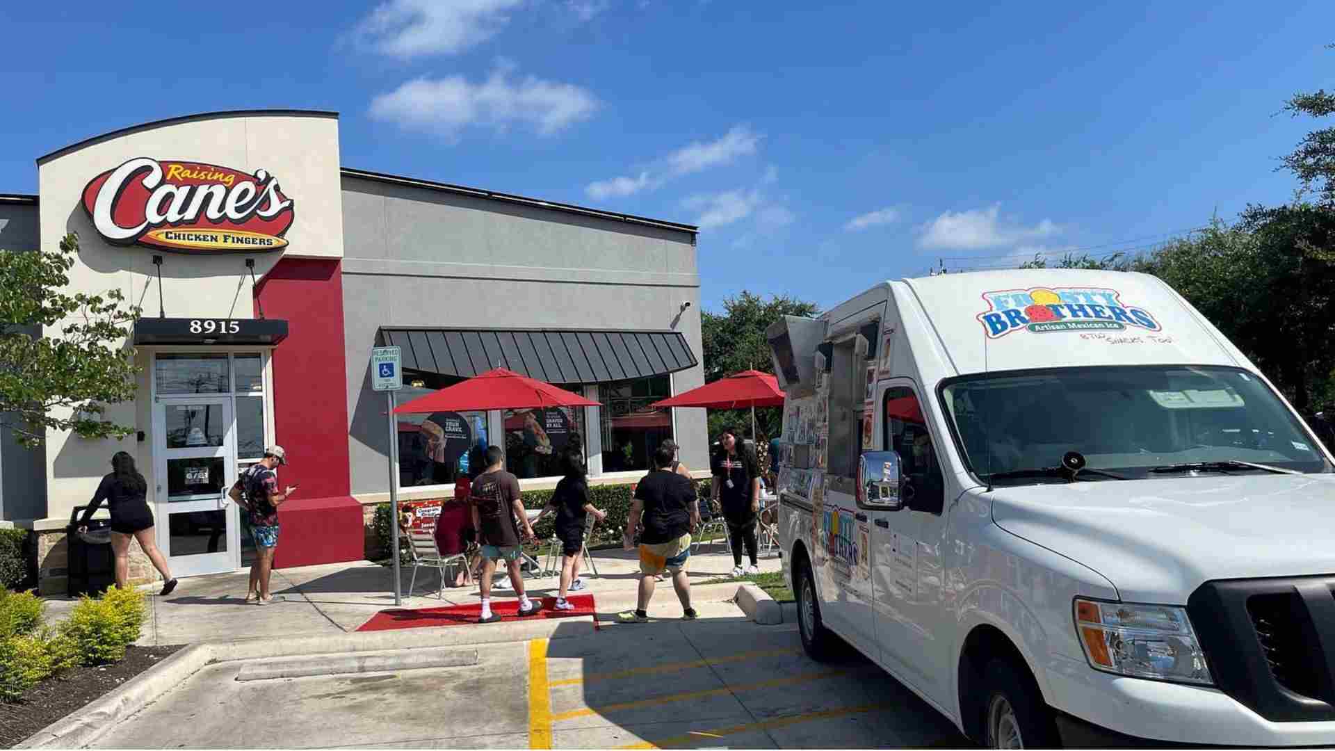 Frosty Brothers Ice Cream Truck catering an employee appreciation event outside Raising Cane's in San Antonio with shaved ice, snacks, and frozen treats for employees.