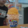 Authentic mangonada  being made with mango shaved ice, chamoy, Tajín, fresh mango, and a tamarind candy straw at Frosty Brothers in San Antonio.